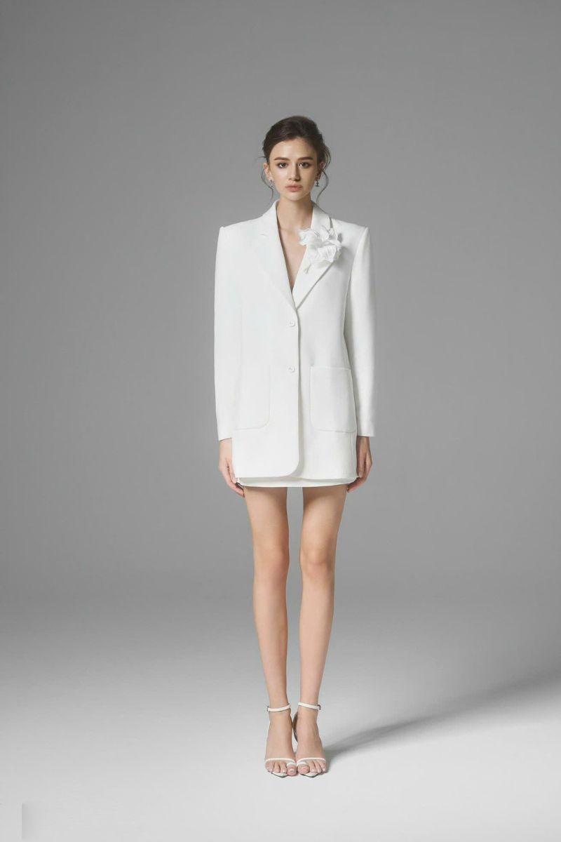 White Ontario mini skirt by Arti Apparel, shown in a stylish close-up image highlighting the fabric and fit.
