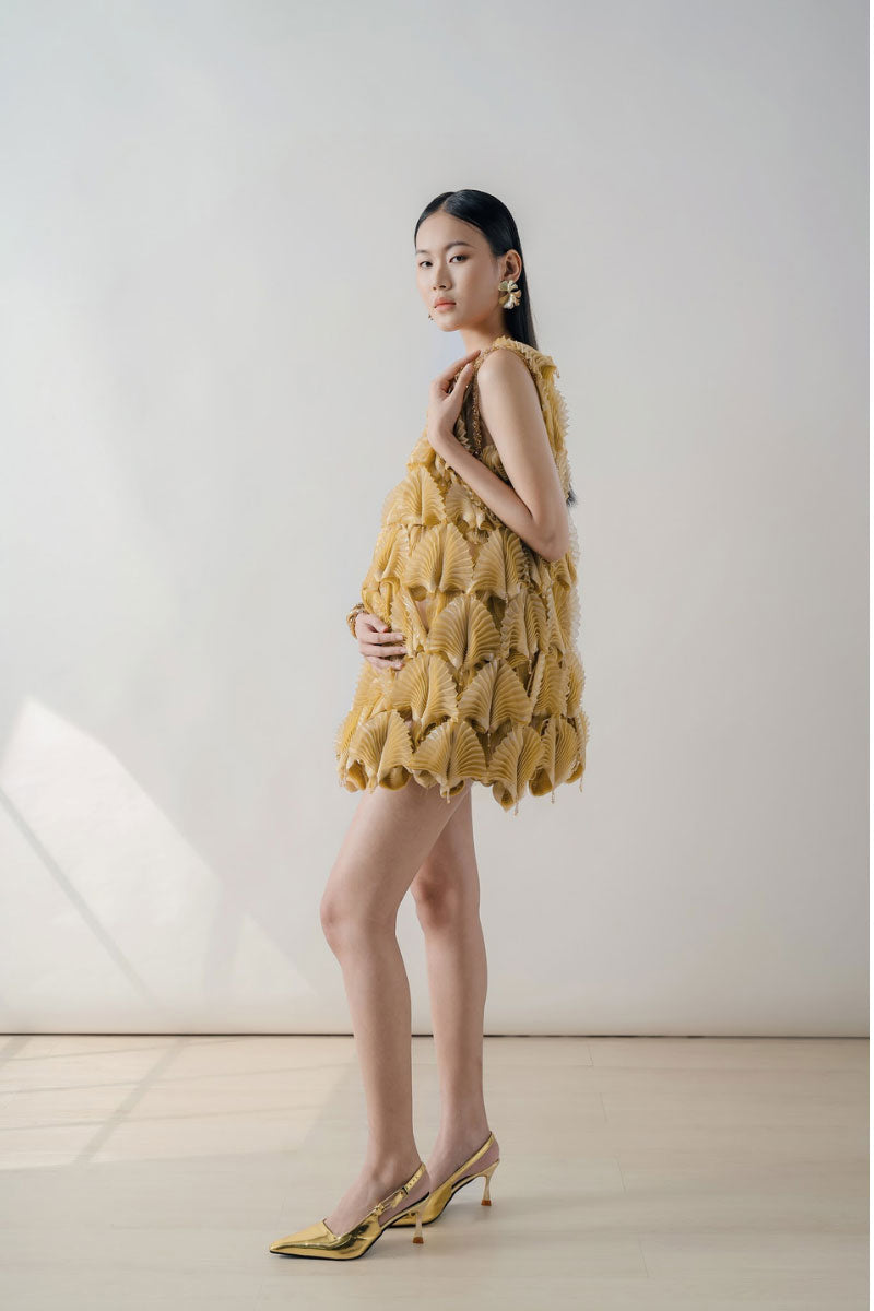 Mustard textured sleeveless mini dress by DOC BAN featuring a fitted silhouette and stylish design.