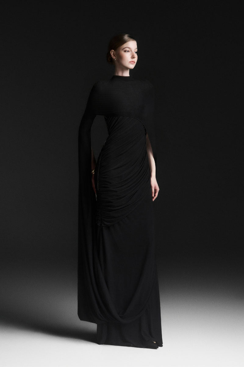 Black Celiora Cape Sleeve Floor Length Maxi Dress by Maison Des Copains, featuring elegant cape sleeves and flowing silhouette.