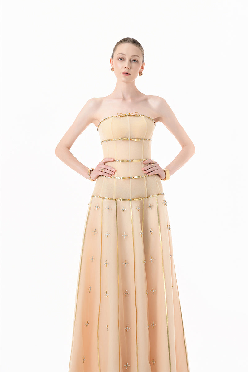 Nude gold-banded embellished A-line gown by Happy Clothing featuring intricate beadwork and flowing fabric.