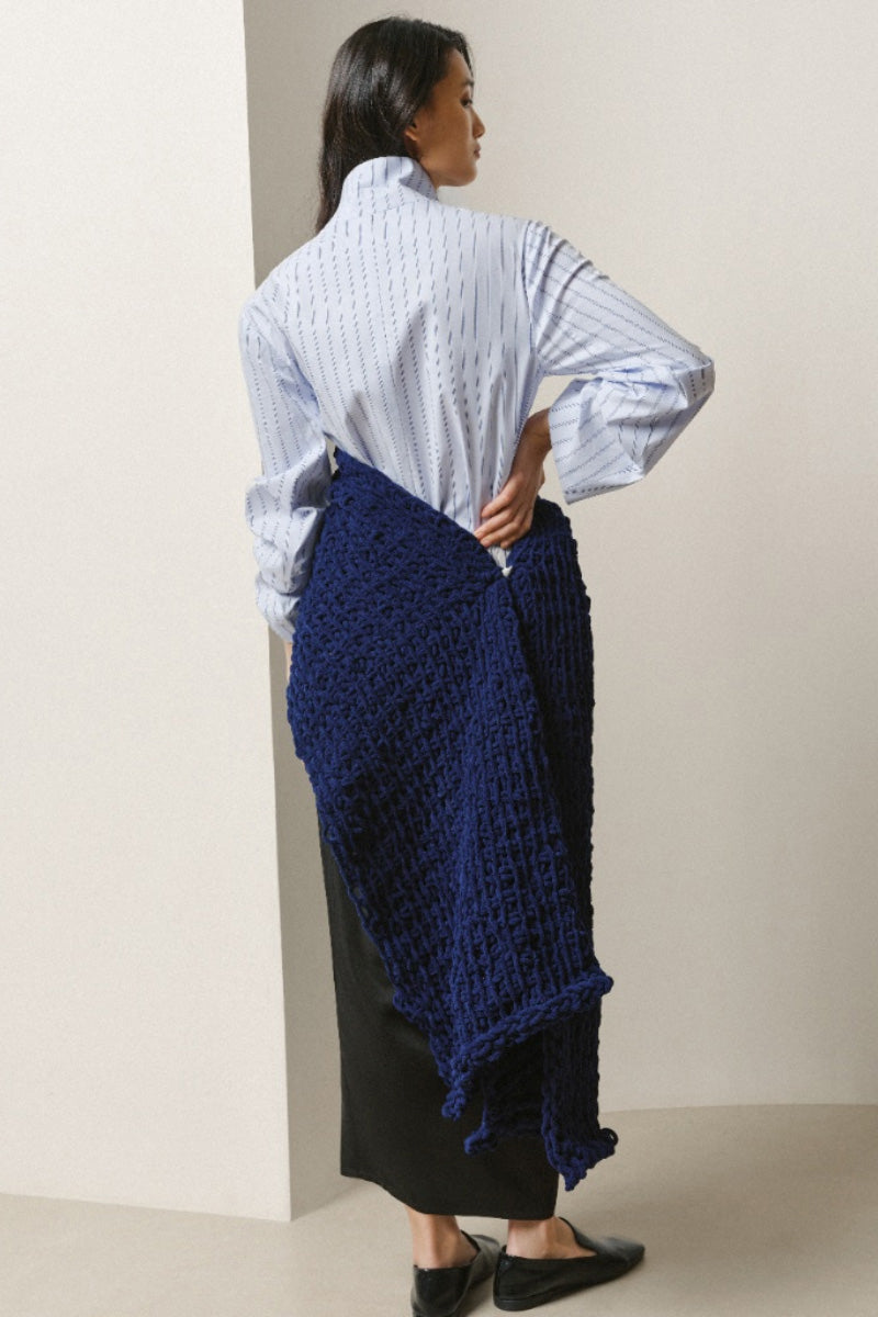 Lecia ruched slit midi skirt in a flowy fabric, featuring a high waist and elegant design, shown on a model.