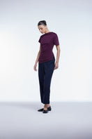 Dāl the Label asymmetrical short sleeve top with uneven hem, lightweight fabric, and modern design, shown on a model.