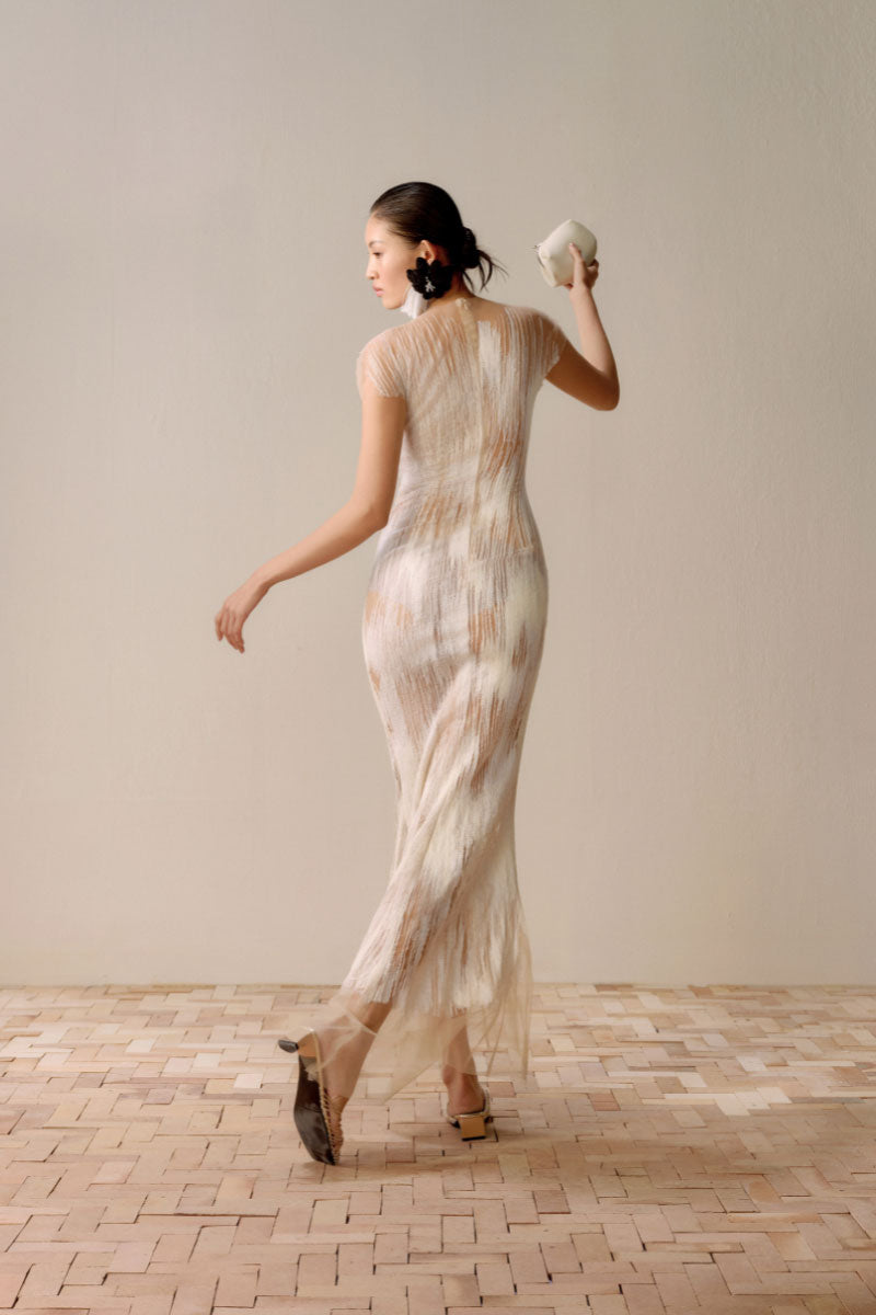 LECIA artisanal Ember midi dress in white, featuring a flowing fabric and elegant design, displayed on a dress form.