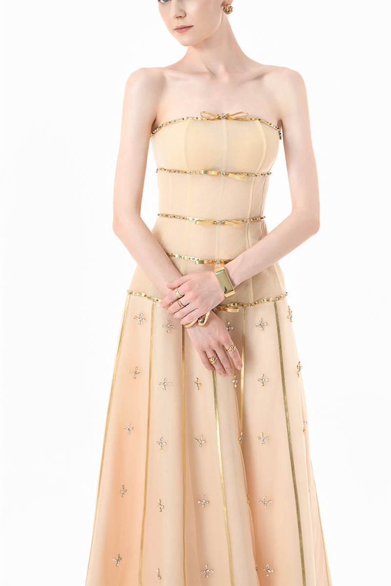Elegant nude gold-banded embellished A-line gown by Happy Clothing, featuring intricate details and flowing fabric.