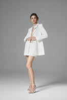 White Ontario mini skirt by Arti Apparel, featuring a fitted design and stylish length, shown on a model.
