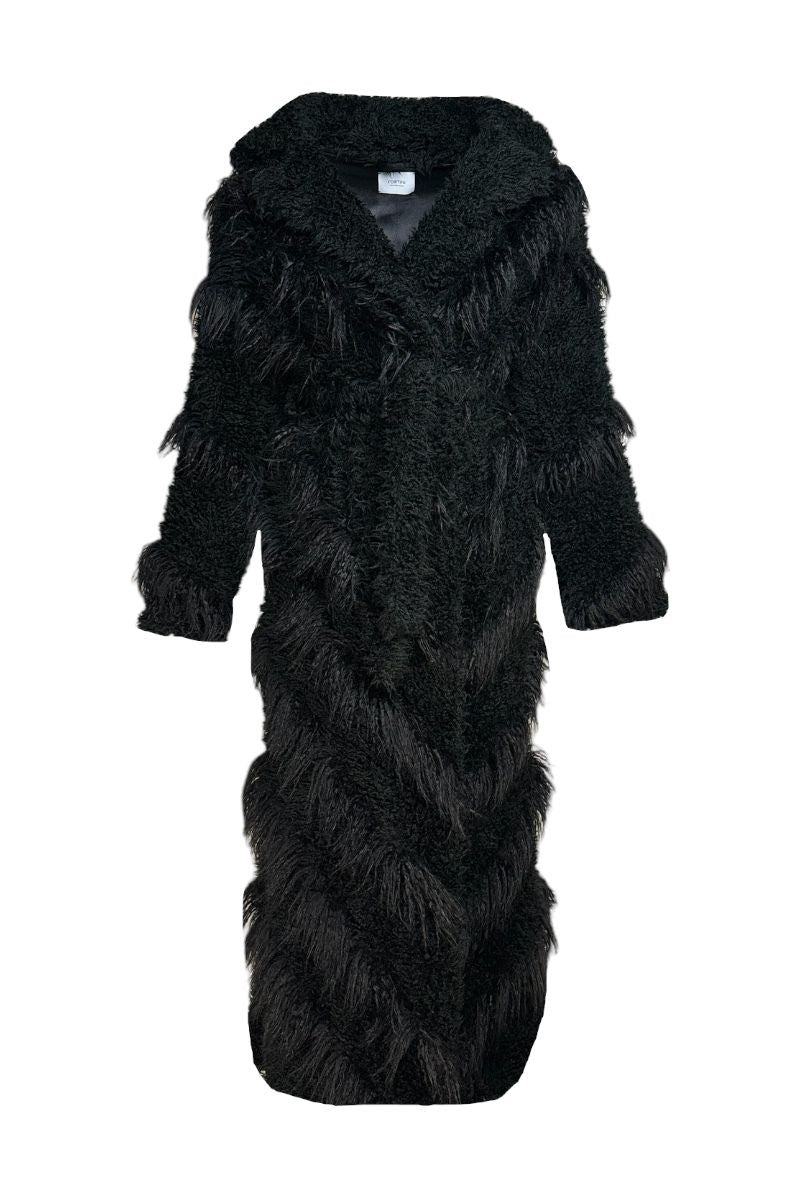 Black faux fur maxi coat with diagonal panel design by Fortini, featuring plush texture and elegant silhouette.