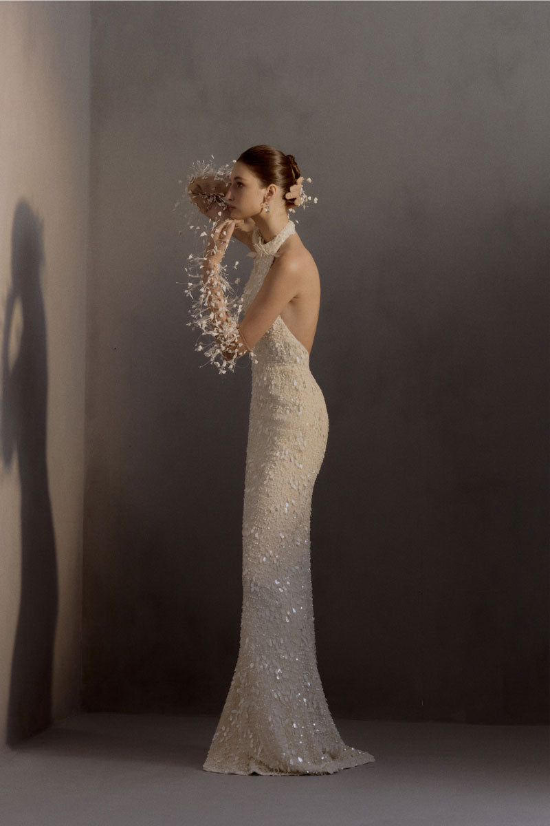 White Plan chiffon gown featuring a flowing, elegant design with delicate fabric and intricate details, perfect for formal occasions.