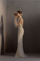 White Plan chiffon gown featuring a flowing, elegant design with delicate fabric and intricate details, perfect for formal occasions.