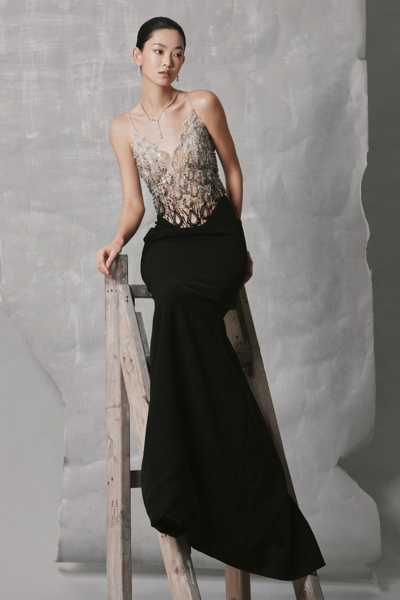 Black round-neck long straight gown by Phan Huy, displayed on a mannequin, showcasing sleek, elegant dress design.
