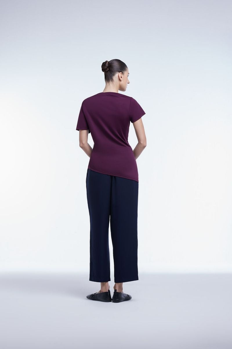 Asymmetrical short sleeve top by Dāl the Label, featuring a stylish, modern design with unique hemline and lightweight fabric.