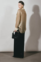 Black long pencil skirt from Lecia, a sleek maxi skirt with a fitted silhouette and smooth fabric, shown on a model.