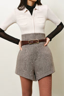 Lecia high-waist A-line shorts in light denim fabric, featuring a classic fit and rolled hem, shown on a model.