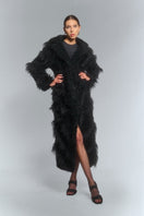 Black faux fur maxi coat with diagonal panel design by Fortini, featuring a plush texture and elegant silhouette.