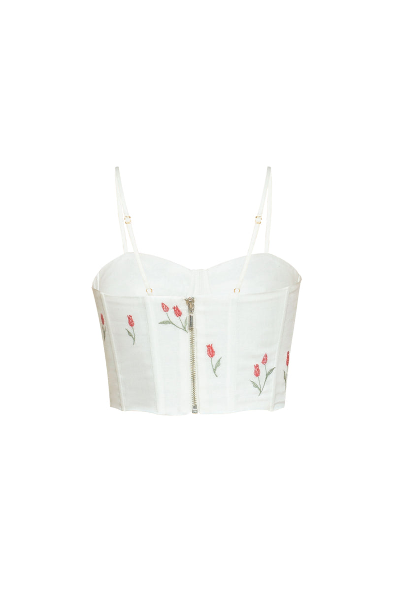 Estefania ivory tulip corset top with fitted design and floral detailing, styled with adjustable straps and a structured silhouette.