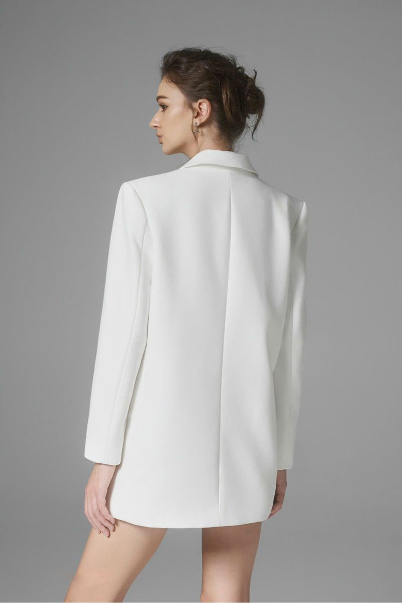 White Ontario mini skirt by Arti Apparel, shown with a fitted waist and stylish hem, perfect for casual or chic outfits.