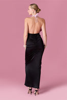 Elegant Nur Karaata Gilded Society gown with intricate gold accents and flowing fabric, showcased on a mannequin.