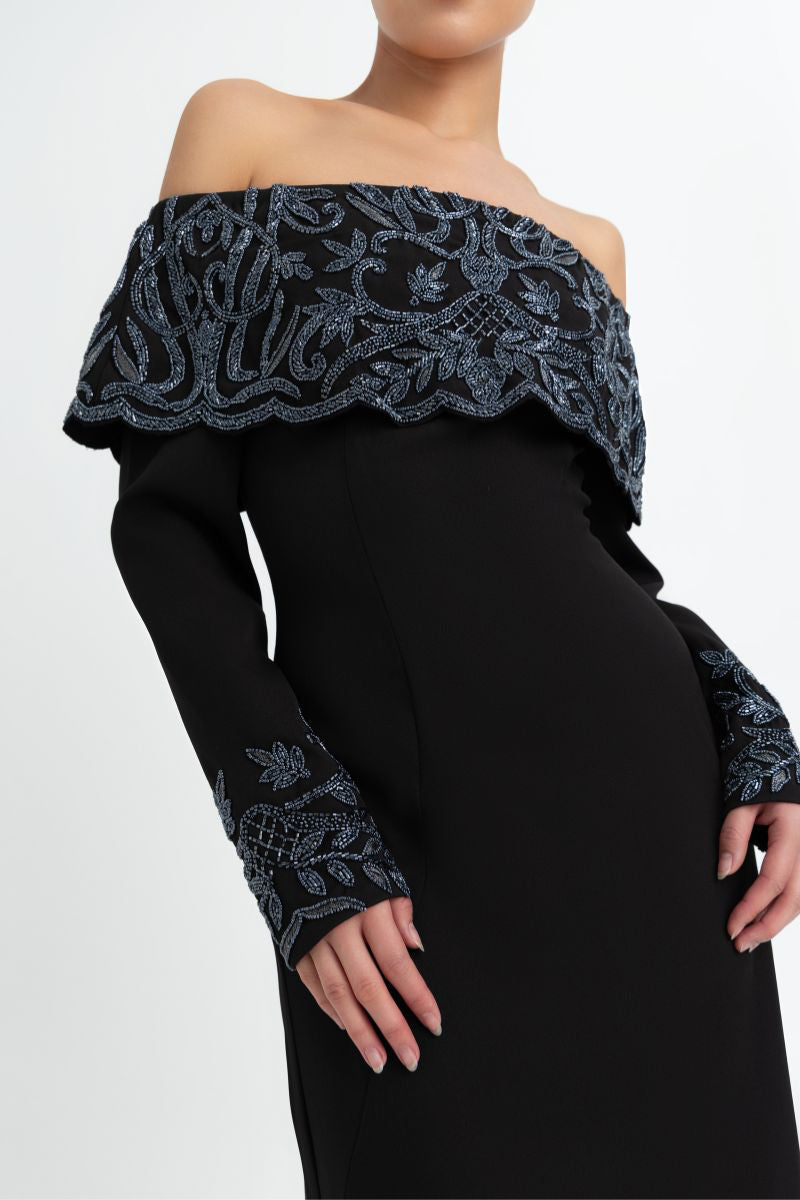 Elegant black gown by Raishma featuring intricate lace details and a flowing silhouette, perfect for formal occasions.