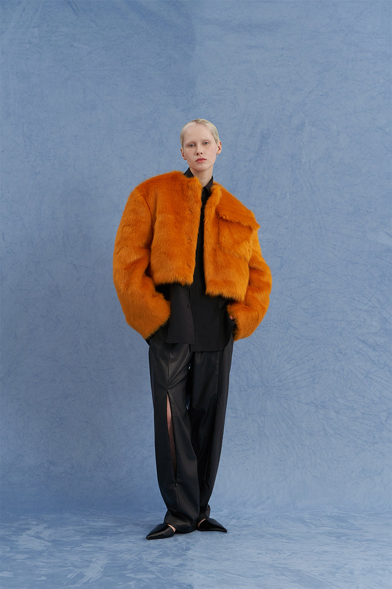 Orange JINSUN exaggerated shoulder shearling jacket with wide lapels and textured shearling collar, stylish and warm for cold weather.