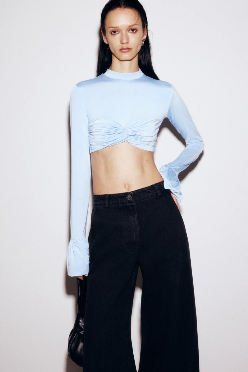Black wide-leg jeans by ELENAREVA, showcasing a relaxed fit and stylish denim fabric with a high waist and wide-leg cut.