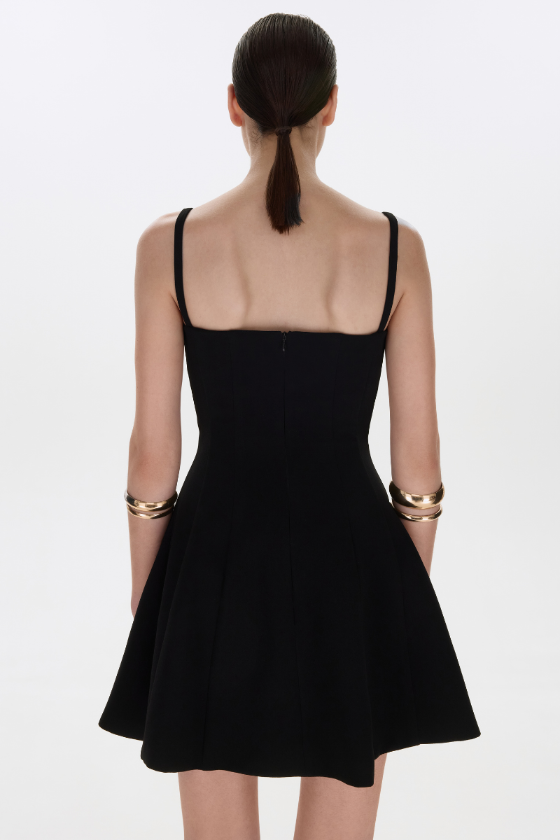 Black BALYKINA mini dress with stylish straps, tailored fit, and sleeveless design perfect for casual or night-out wear.