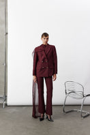 Nazlı Ceren Arced trousers in Bordeaux color, stylish pants with a tailored fit, shown on a model.