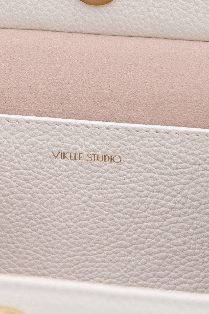 White CELINE mini top handle bag with sleek design, featuring a compact shape and elegant style from VIKELE STUDIO.