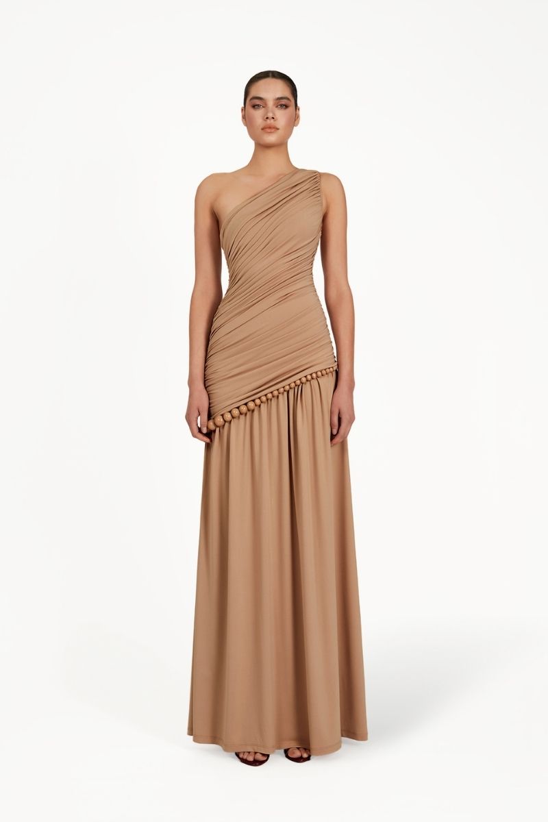 Khanum's tan KASBA maxi dress featuring a flowing silhouette and elegant design, perfect for casual or formal occasions.