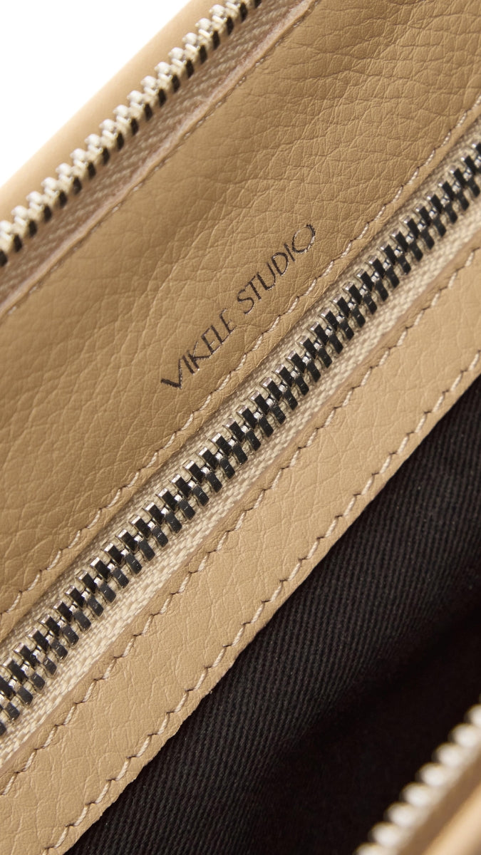 VIKELE STUDIO Denise mini beige shoulder bag with adjustable strap and sleek design, perfect for casual or evening outings.