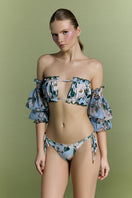 Nur Karaata Misty Mirage bikini in vibrant print, featuring triangle top and matching bottoms, laid flat on a white background.