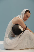 Black VIKELE STUDIO Maria Mini Bag with top handle, showcasing its compact design and smooth leather finish.