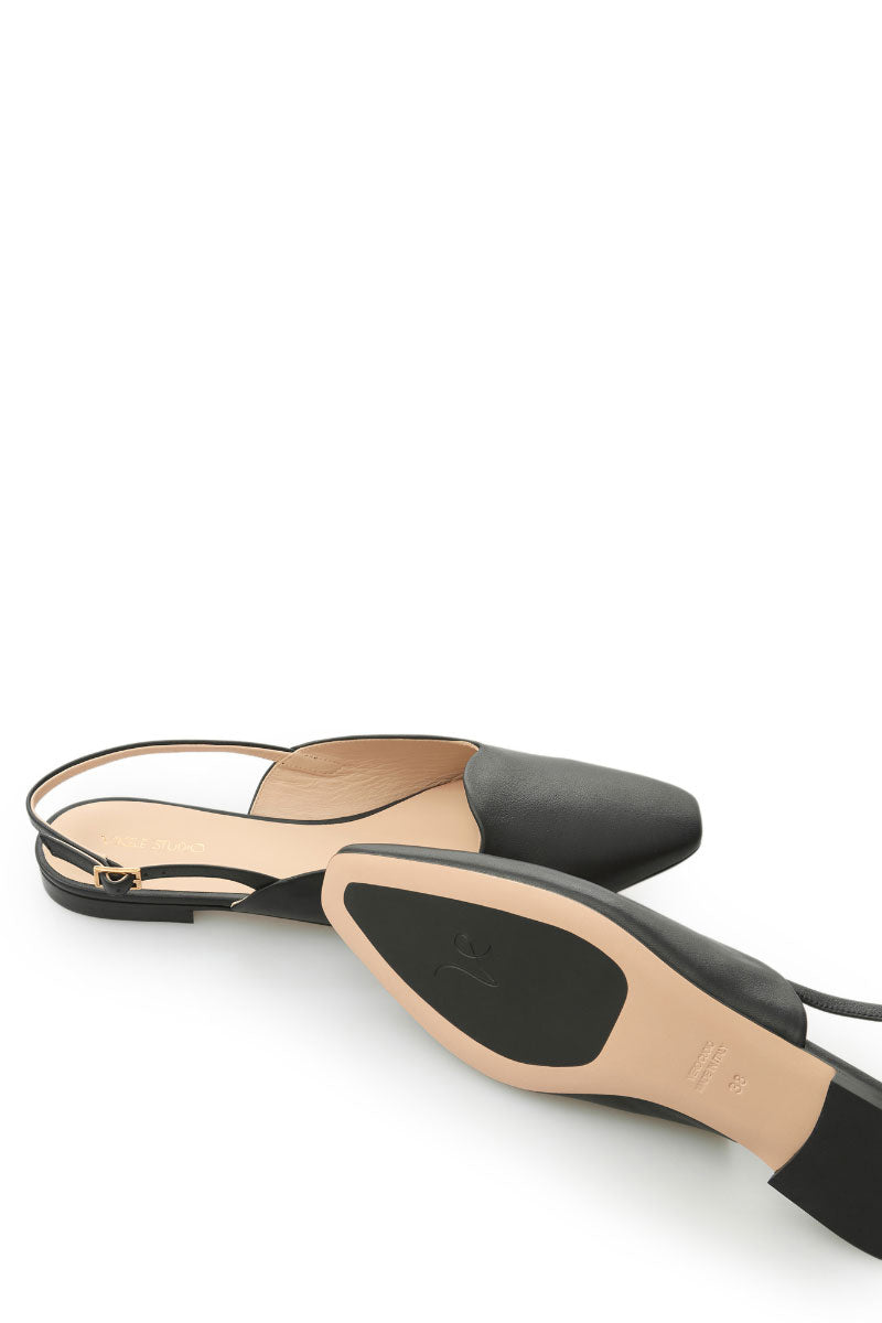 Black Vikele Studio slingback flats sandals with open heel and pointed toe, featuring a sleek and minimalist design.