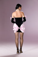 Nur Karaata velvet society mini dress shown in deep burgundy with long sleeves and a fitted silhouette.