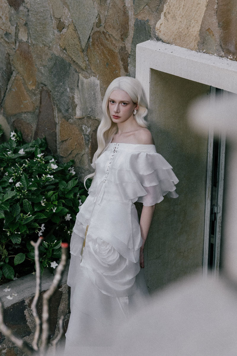 White Plan Thomas dress, a stylish maxi dress with a flowing silhouette, displayed on a hanger against a neutral background.