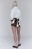 ZUT Ellis leather shorts shown on a model, featuring a fitted design and classic leather texture, ideal for casual or edgy outfits.