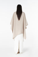 Lili Blanc oversized cardigan cape in soft knit fabric, draped open-front design with wide sleeves and cozy fit.