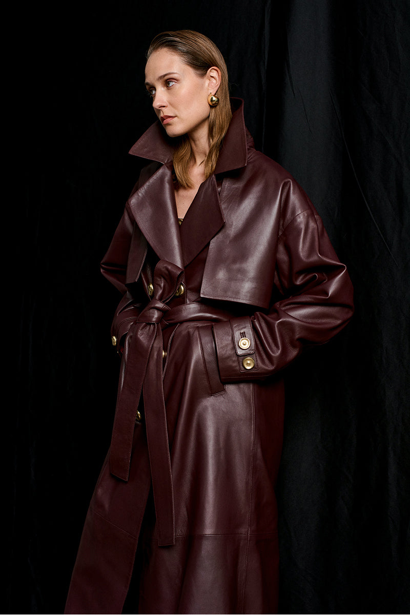Acaria Studio Journey Leather Trench Coat in Cherry, featuring a stylish leather design with a tailored fit and classic trench silhouette.