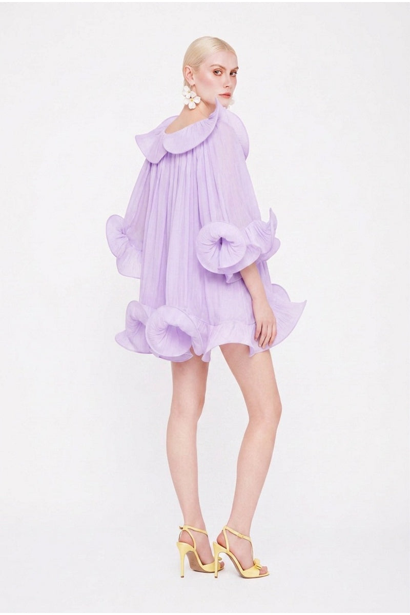 Purple Valenciani Origami Cloud Mini Dress displayed on a mannequin with ruffled details and a fitted silhouette.