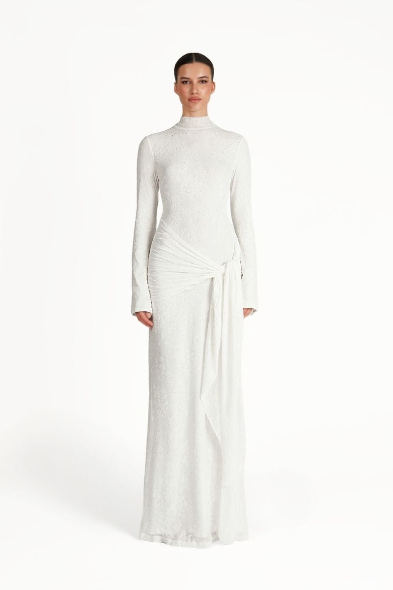Khanum's white maxi dress with flowing fabric and elegant design, perfect for casual or formal occasions.