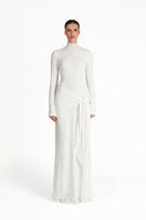 White KELI maxi dress by Khanum's featuring a flowing, elegant design with a fitted waist and long sleeves.