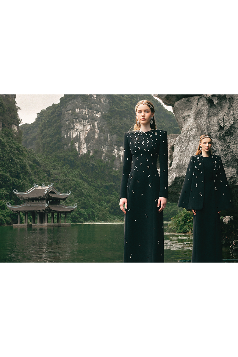 Black stone-embellished long-sleeve gown by Tracy Studio featuring elegant design and intricate detailing.