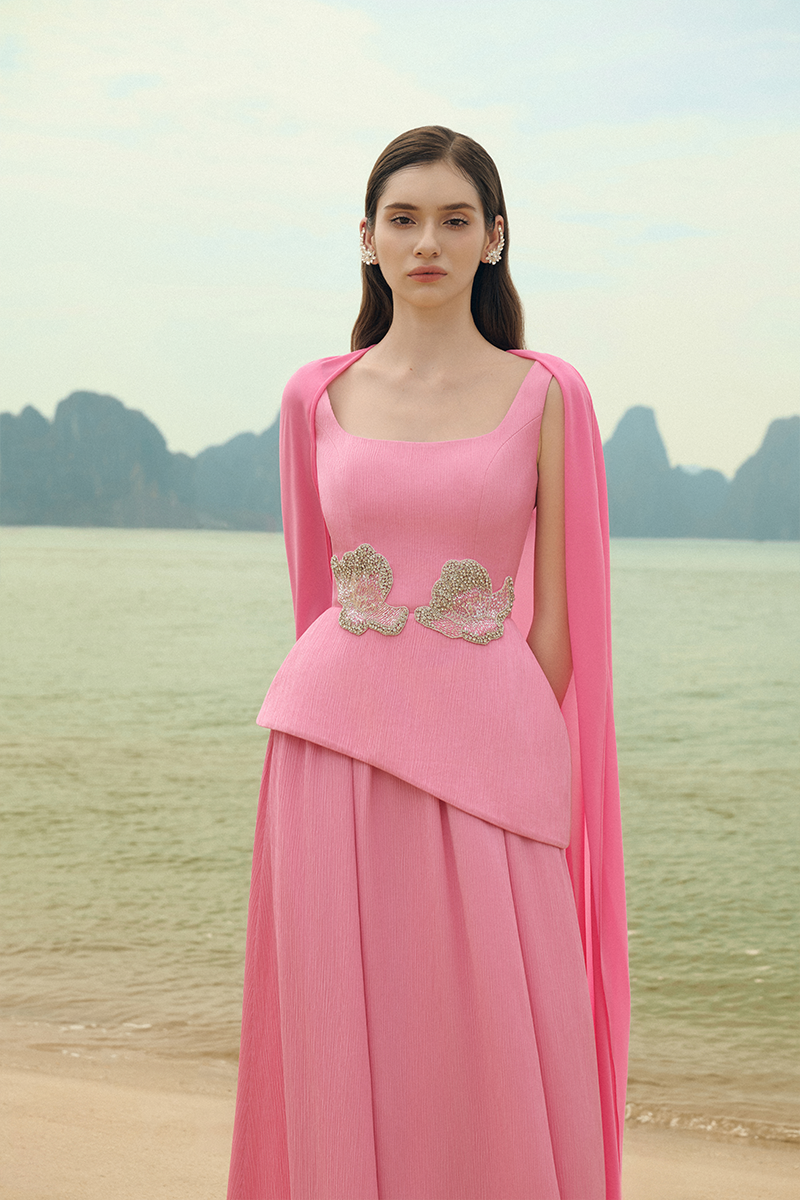 Lune De Soie ruched silk gown with elegant draping, showcasing a luxurious, flowing design in a soft, silky fabric.