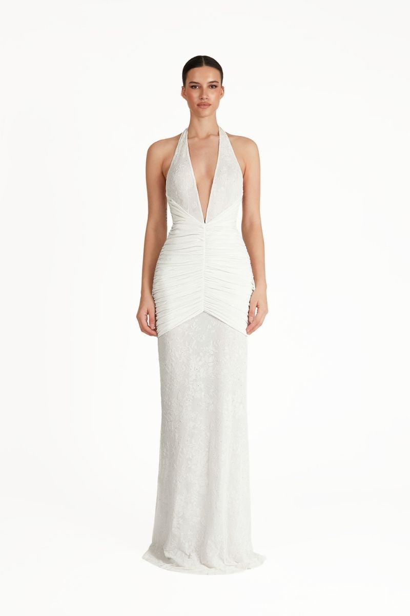 White KAYLIN maxi dress by Khanum's featuring a flowing design and elegant fit, shown on a model.