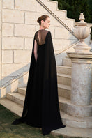 Black velvet satin cape sleeve gown by Tracy Studio, featuring elegant flowing fabric and sophisticated design.