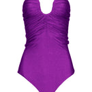 Purple Laura Escobar Serrania one-piece swimsuit with stylish cutouts, shown on a model against a neutral background.
