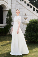Tracy Studio grain weave gown featuring a flowing design with textured fabric and elegant silhouette.