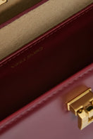 VIKLE Studio Stephanie burgundy top handle bag with sleek design and gold-tone hardware on a neutral background.
