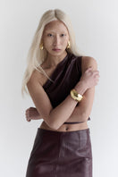 ZUT Laurel leather top showing a fitted black leather sleeveless design with a V-neck and sleek texture.