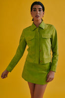 Green MINI ALISHA jacket by ZUT, lightweight and stylish, shown on a hanger with a close-up of the fabric and zipper details.