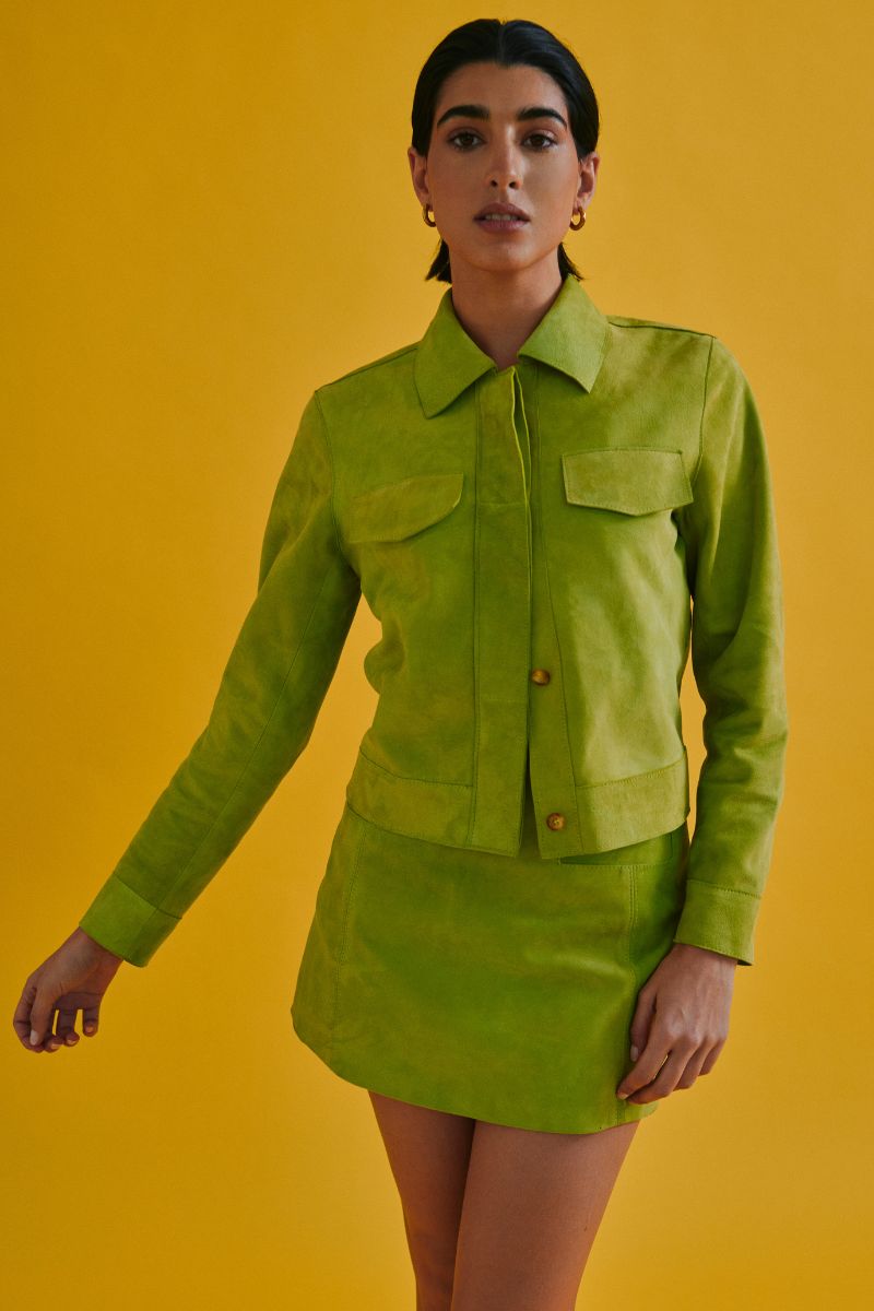 Green MINI ALISHA jacket by ZUT, lightweight and stylish, shown on a hanger with a close-up of the fabric and zipper details.