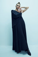 Black satin maxi dress with one-shoulder design by Nazlı Ceren, featuring elegant draping and a flowing silhouette.